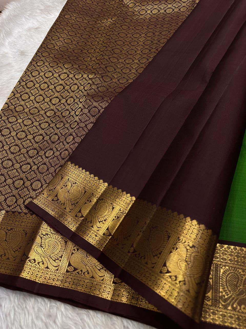 Green pure silk Kanchipuram saree with zari motif wirh deep chocolate brown shot purple silk Kanchipuram saree with vanasringaram border and Pallu