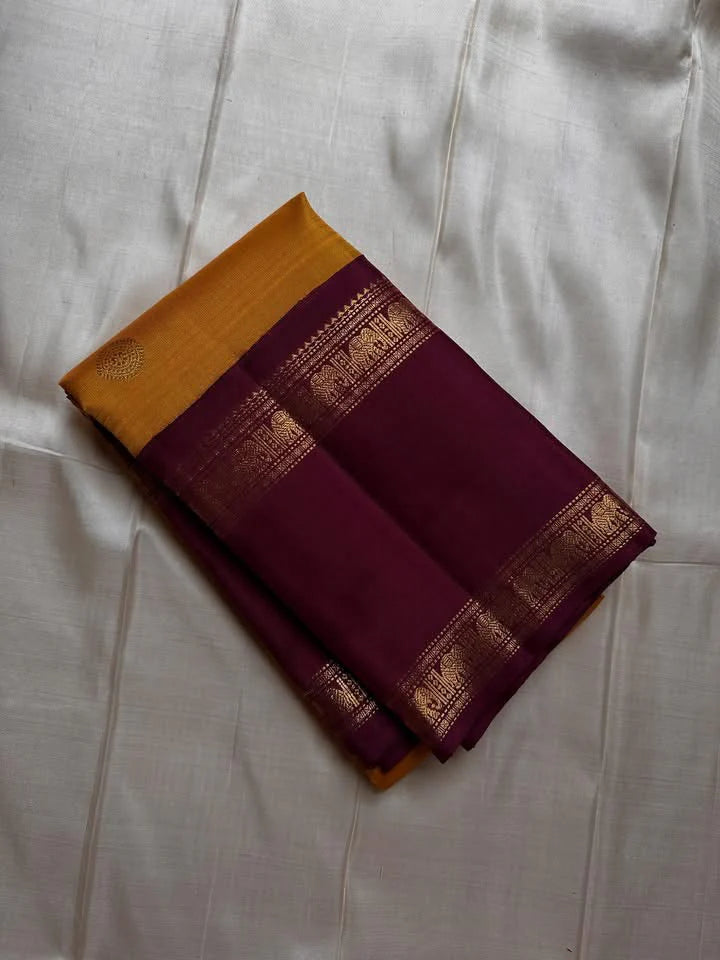 Bhanu – Mustard Gold Handwoven Kanchipuram Silk Saree with Deep Coffee Brown Borders, Intricate Elephant Motif Zari, and a Grand Temple-Inspired Pallu