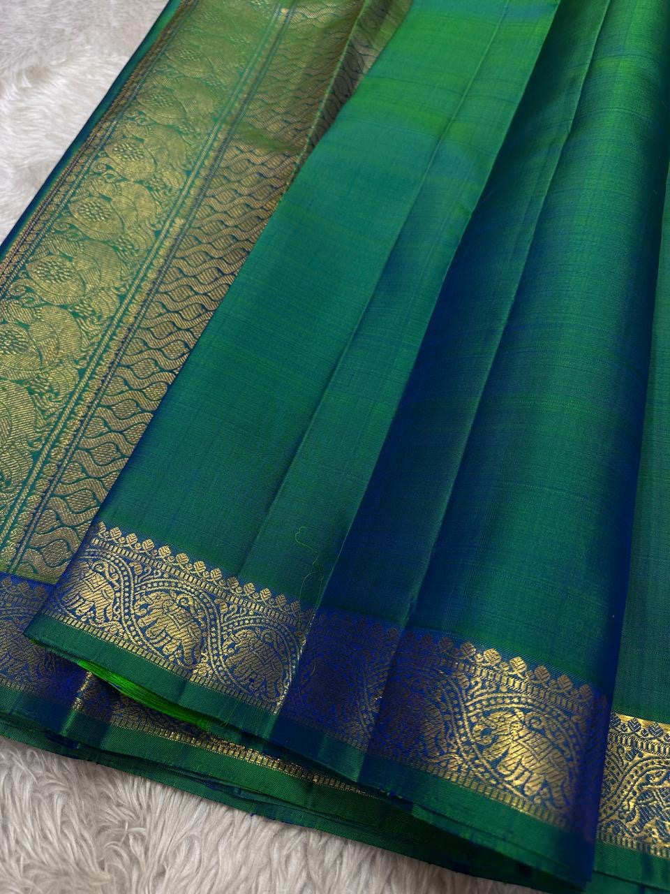Peacock green blue shot pure silk Kanchipuram saree with vanasringaram border and Pallu