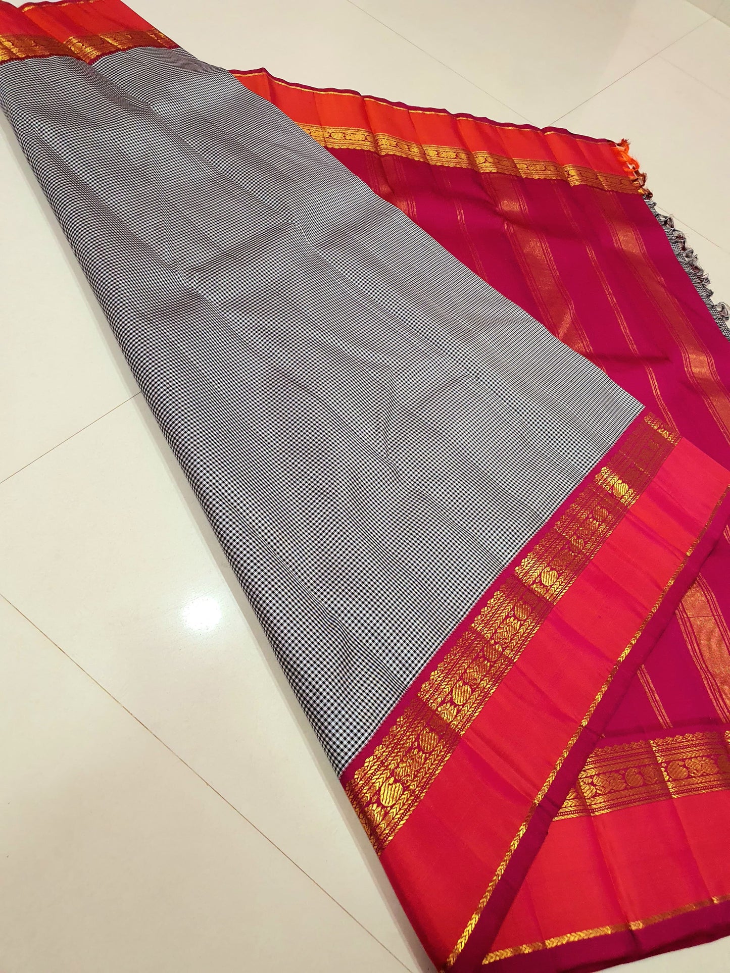 Rani Ember Podi Kattam – Pure Kanchipuram Silk Saree
Micro Black & Ivory Checks with Korvai Rani Magenta Border
Gold Zari Coin & Floral Vine Detailing with Vermilion Selvedge
Rich Rani Magenta Zari-Striped Pallu |
Silk Mark , free shipping within 2 weeks