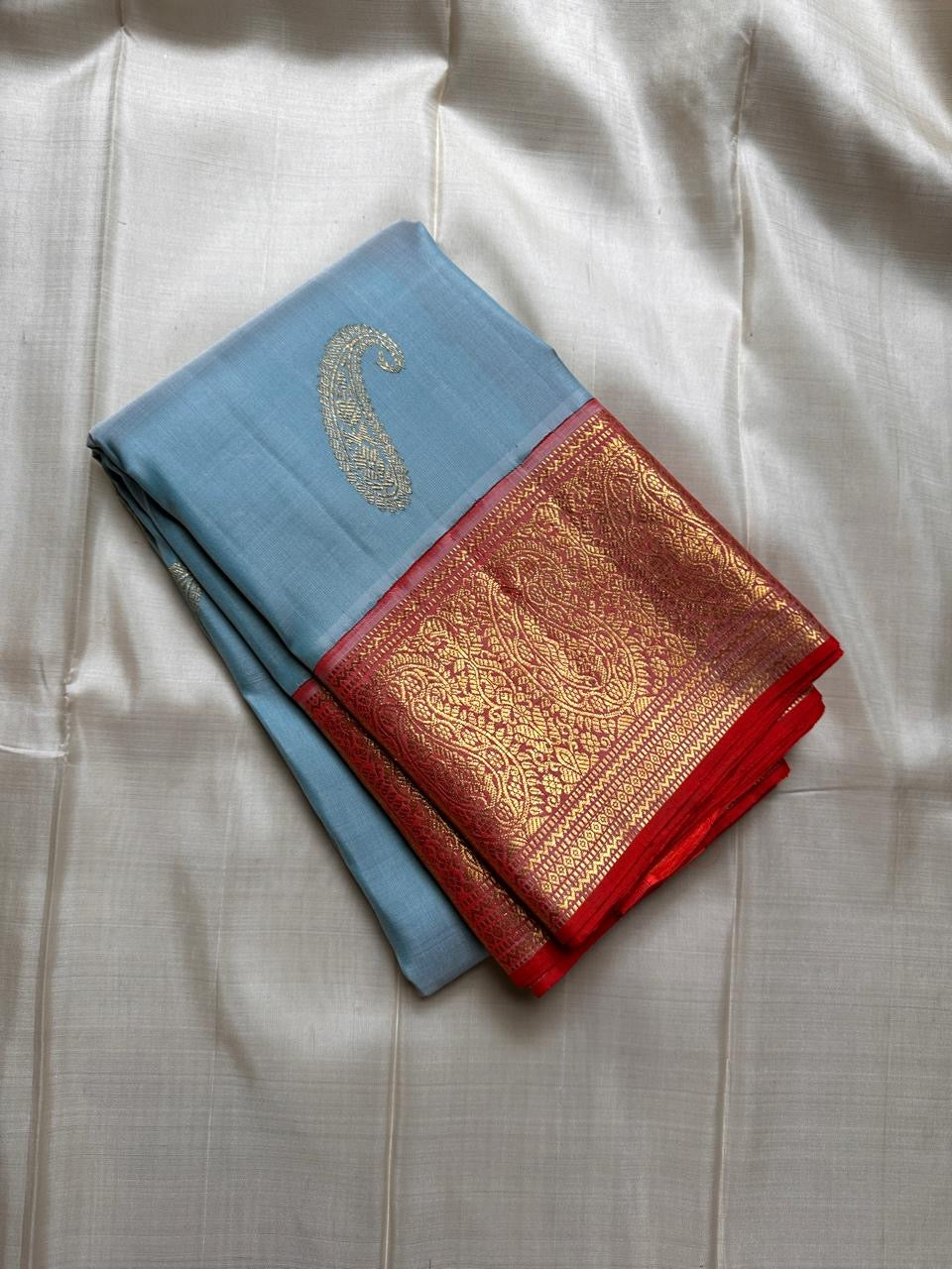 A saree where sky blue melts into sunrise orange—pure silk Kanchipuram magic.