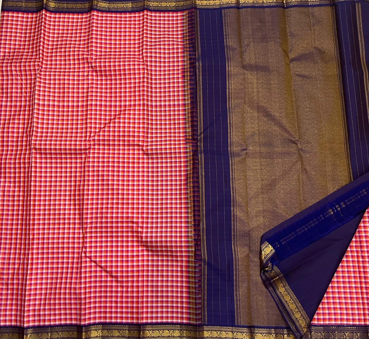 Rani Kanthi — Pure Silk Kanchipuram Saree
Sunset-orange, rani-pink & haldi-yellow kattam checks ✨
Navy korvai borders with intricate gold zari vines
Rich navy pallu with zari pinstripes & tasseled finish
Silk Mark Certified • Free USA Shipping in 1 week