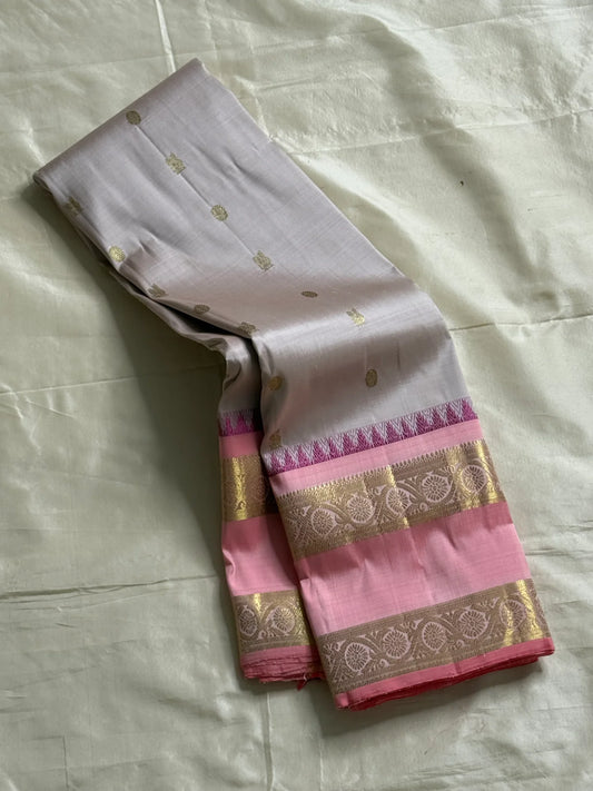 Pink pearl - Pure Kanchipuram Silk with petite chakram zari buttas
Contrast rose-pink border with magenta temple (reku) peaks & floral vine zari
Silk Mark Certified • Free USA Shipping • Ships in Two Weeks