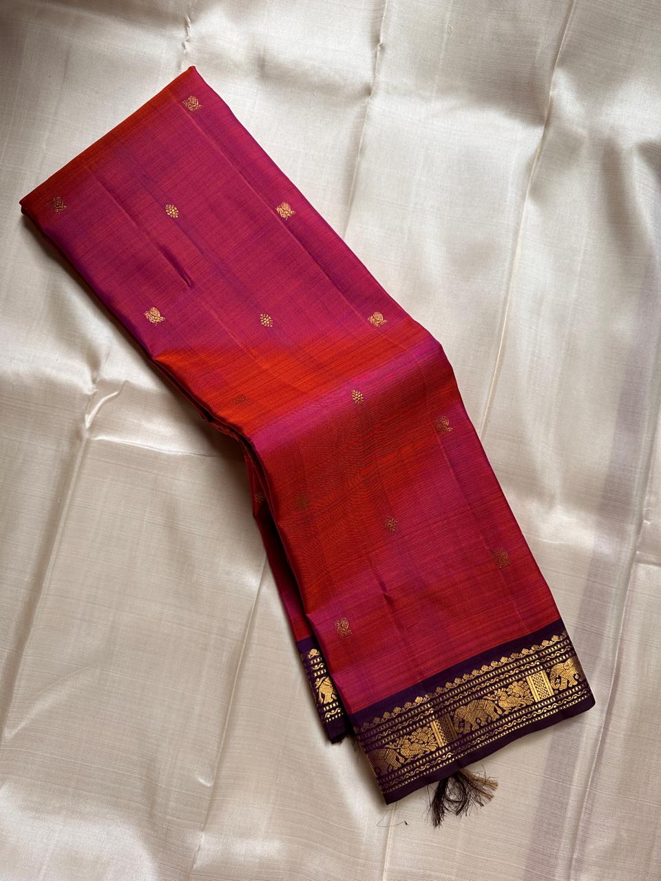 Anju ✨ – Red & Rust-Orange Shot Kanchipuram Pure Silk Saree
with Majestic Elephant & Peacock Motifs
Regal Deep Purple Korvai Contrast Border
Opulent Gold Zari Brocade Pallu