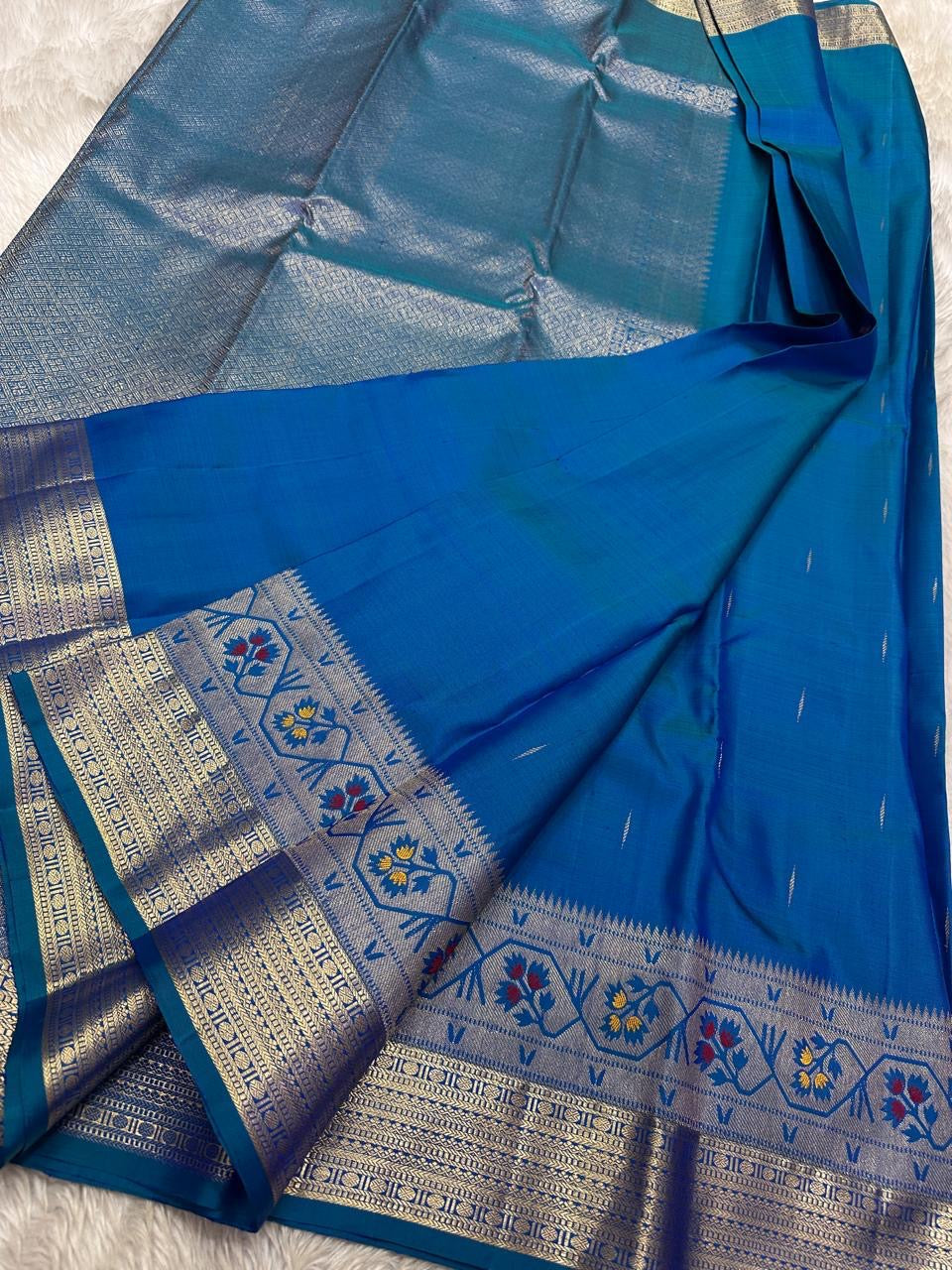 Vibha peacock blue green shot double color Pure Kanchipuram Silk Saree Blending the Grandeur of South Indian Weaving with Paithani-Inspired Floral Zari Borders and a Lustrous Rose Gold zari Pallu