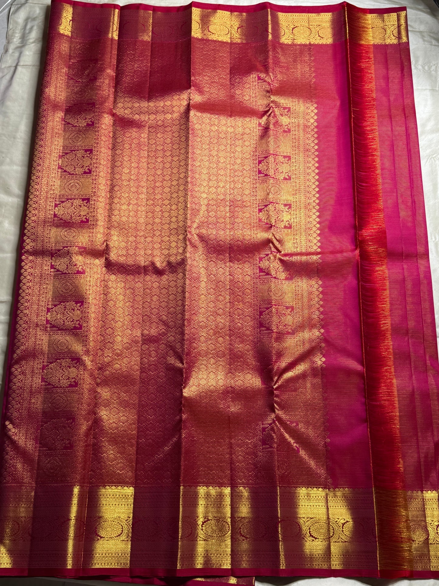 Nakshatra – Radiant pink Vairaoosi Kanchipuram Silk Saree Adorned with Mayil & Chakram Zari Buttas, Featuring an Ornate Kamalam and Floral Vine Zari Border, Flanked by Varisaipet Motifs, and a Pallu Woven with Sacred Thulasi Madams and Regal Kamalams