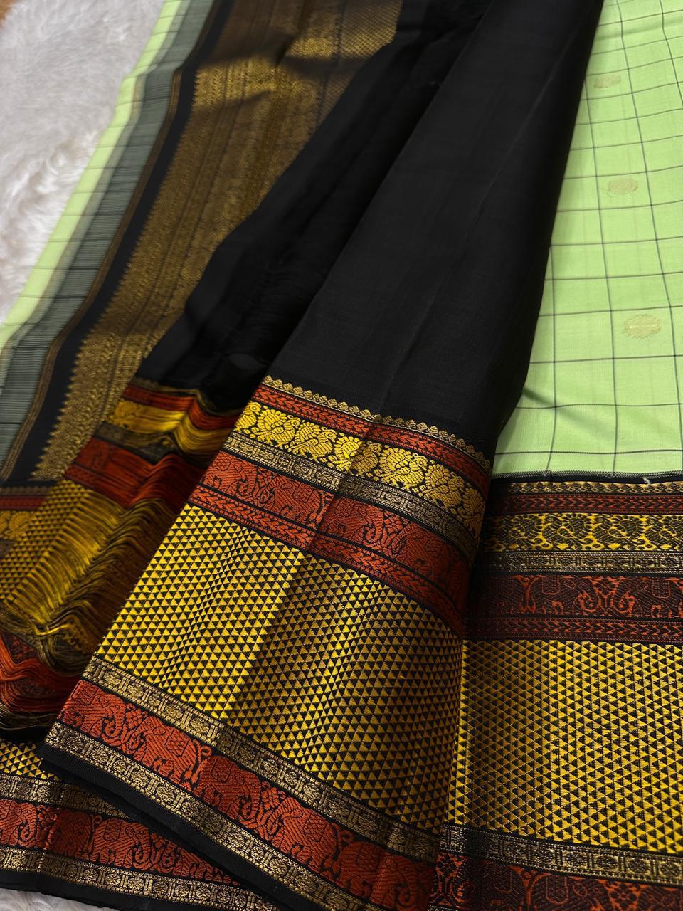 ✨ Elakkai Kattam — Pure Silk Kanchipuram Saree ✨
Cardamom-green body with black kattam checks and gold buttas, contrasted by kumkum-rust & kanak-gold borders with elephant zari and a rich black brocade pallu.
Silk Mark Certified ✅ • Fall & Pico Done ✅ •