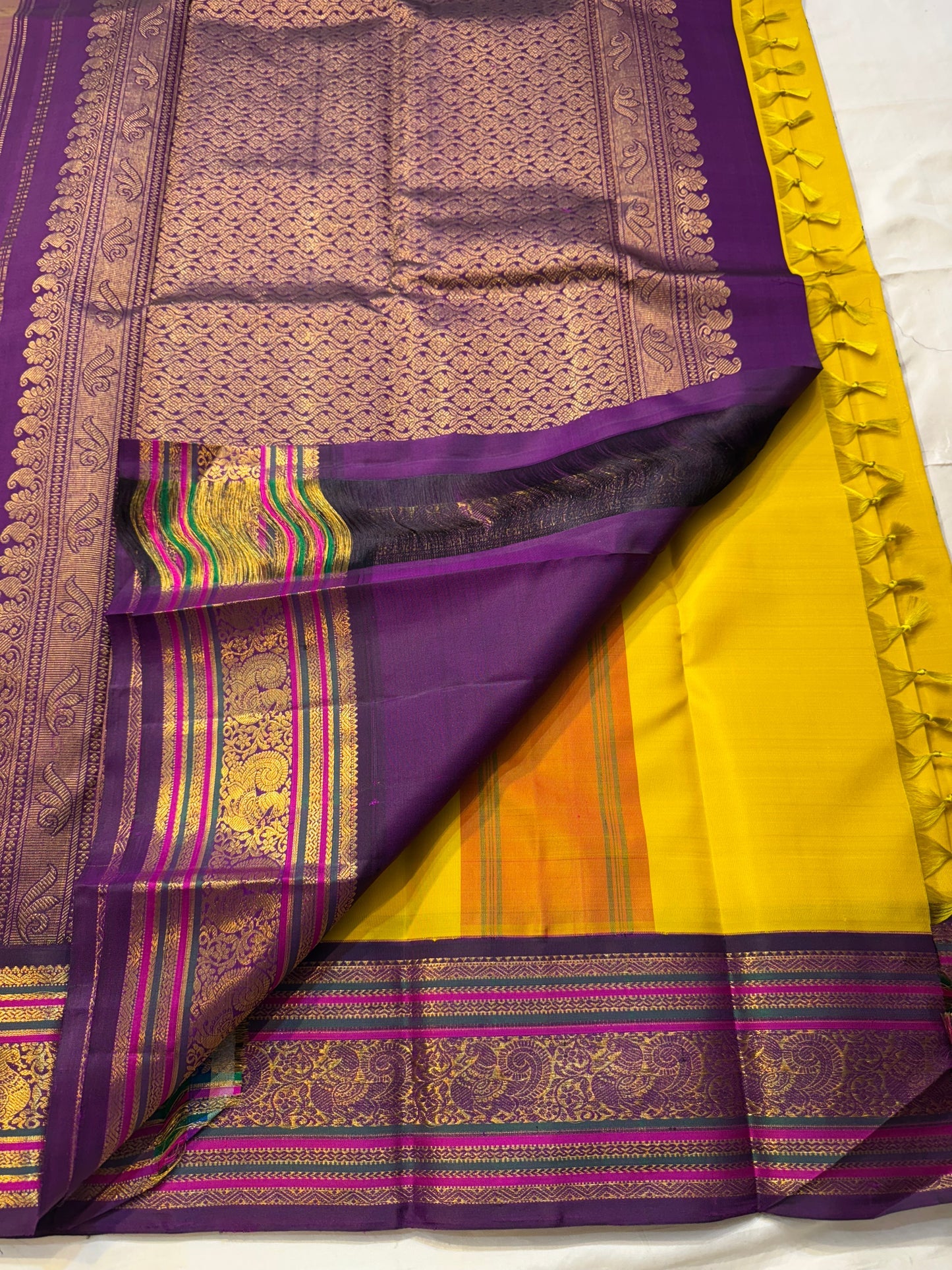 Kili Manjari — Pure Silk Kanchipuram
Haldi Yellow • Parrot & Coin silk thread Buttas • Plum Zari Border
Silk Mark Certified ✅ Free  Shipping ✅ Ships in 1 week ✅