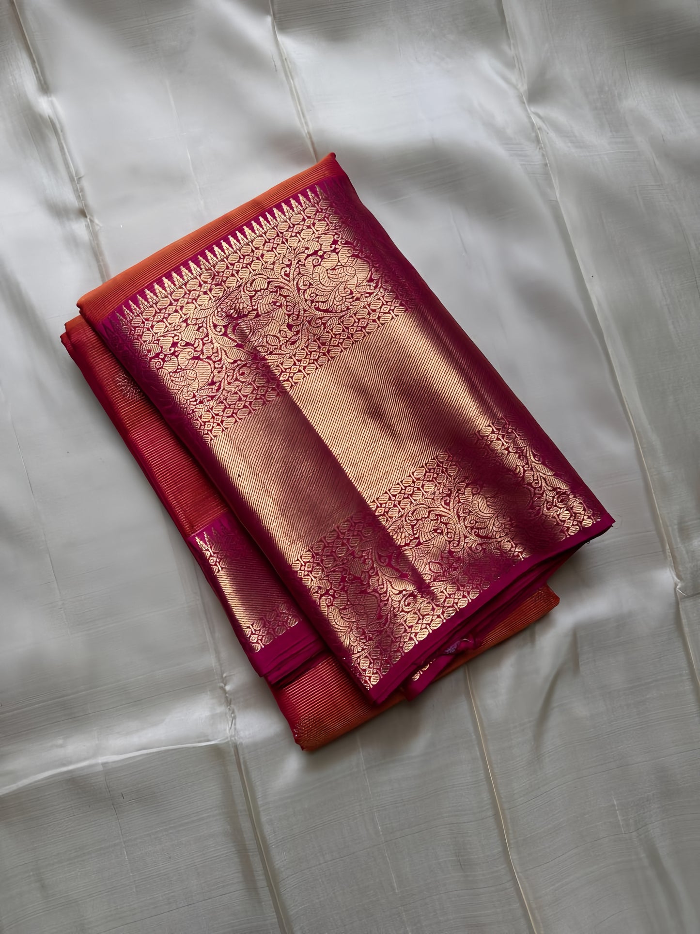 Vairaoosi - silk Kanchipuram thanga velli ( sonaroopa) zari butta in a mesmerizing rust red korvai getti (thick ) zari border with mayil motif