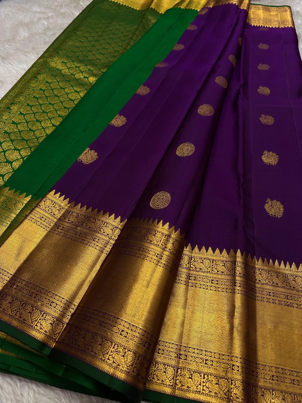 A majestic union of deep purple silk and emerald grace! Mayil chakram butta peacock border