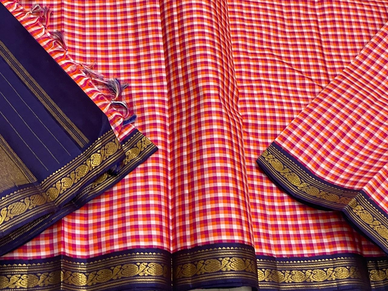 Rani Kanthi — Pure Silk Kanchipuram Saree
Sunset-orange, rani-pink & haldi-yellow kattam checks ✨
Navy korvai borders with intricate gold zari vines
Rich navy pallu with zari pinstripes & tasseled finish
Silk Mark Certified • Free USA Shipping in 1 week