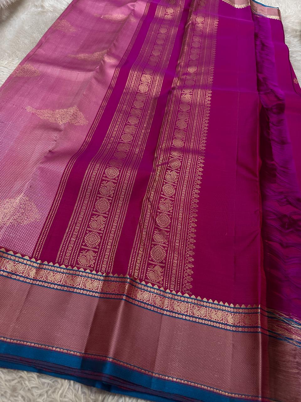 Pink Lily — Pure Silk Kanchipuram
Rani-pink body with zari buttas, dusty-mauve korvai borders & teal selvedge highlights ✨
Silk Mark Certified • Antique Zari Weave • Ships in Two Weeks • Free Shipping within USA