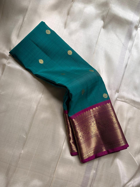 Peacock Green Pushpam – Pure Silk Kanchipuram Saree
 floral butta body with magenta contrast floral zari border
Grand woven zari pallu with traditional medallions & motifs
Silk Mark Certified | Free Shipping within USA
Ships in 1 Week | Fall & Pico