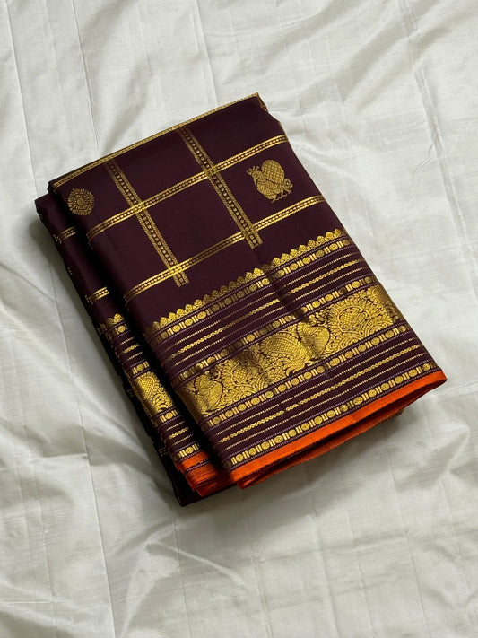 Then Thuli — Pure Silk Kanchipuram Saree
Coffee plum with gold kattam checks & mango buttas
Antique-gold peacock borders, brocade pallu, tasselled finish
Silk Mark Certified ✅ • Ships in Two Weeks ✅ • Free USA Shipping ✅