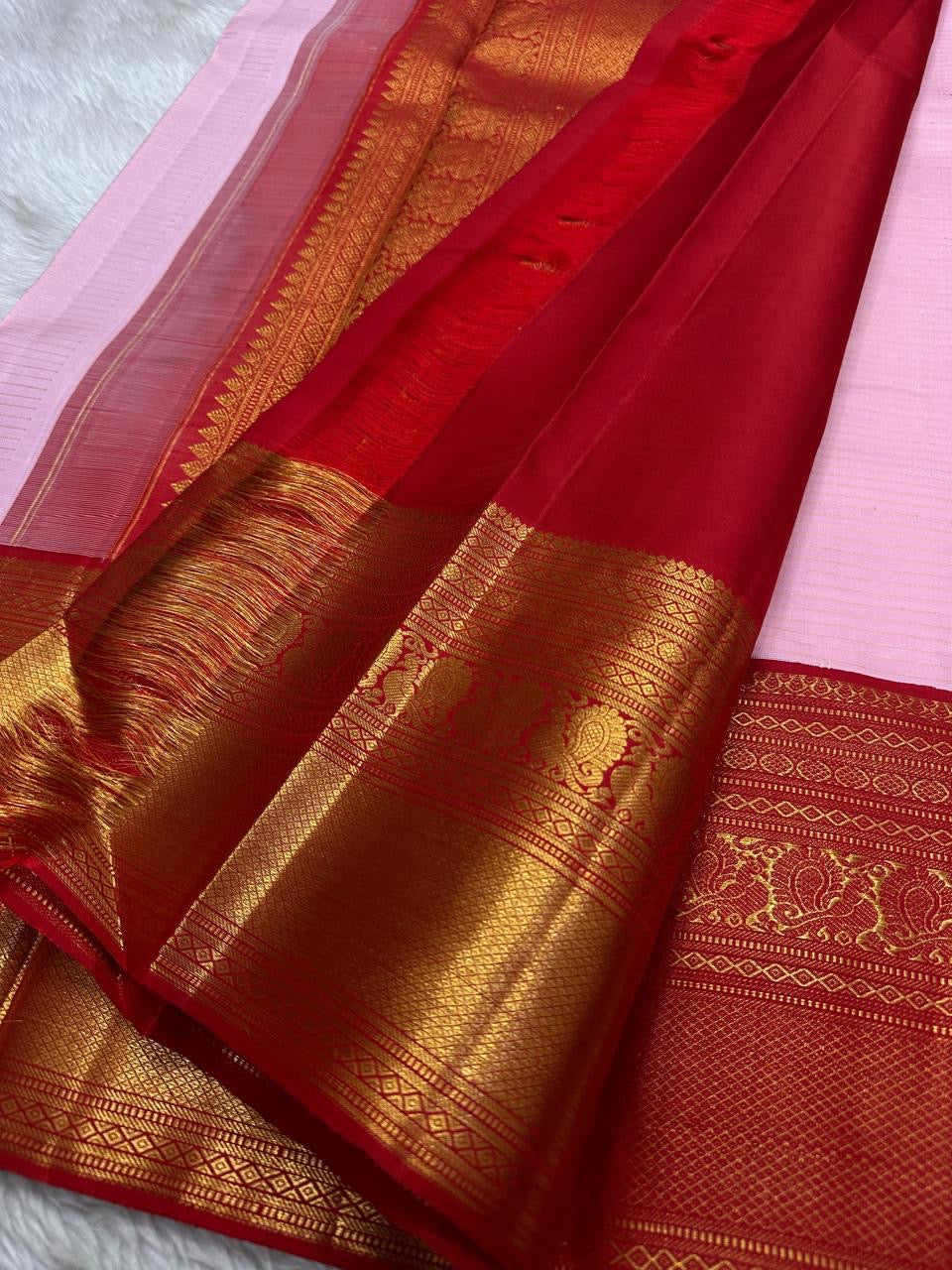 Padma Kungumam — Pure Silk Kanchipuram Saree
Soft lotus-pink body with delicate gold coin buttas and fine oosi stripes, paired with a kumkum-red korvai border in antique-gold lotus brocade.
Silk Mark Certified • Blouse Stitching ($30) • Free USA Shipping