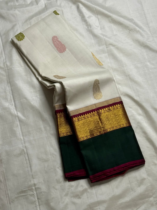 Ivory Malligai — Pure Silk Kanchipuram Saree
Ivory body with multi-color paisley buttas and gold zari diamond border
Arakku pallu with floral zari weave | Silk Mark Certified | Ships in Two Weeks | Free USA