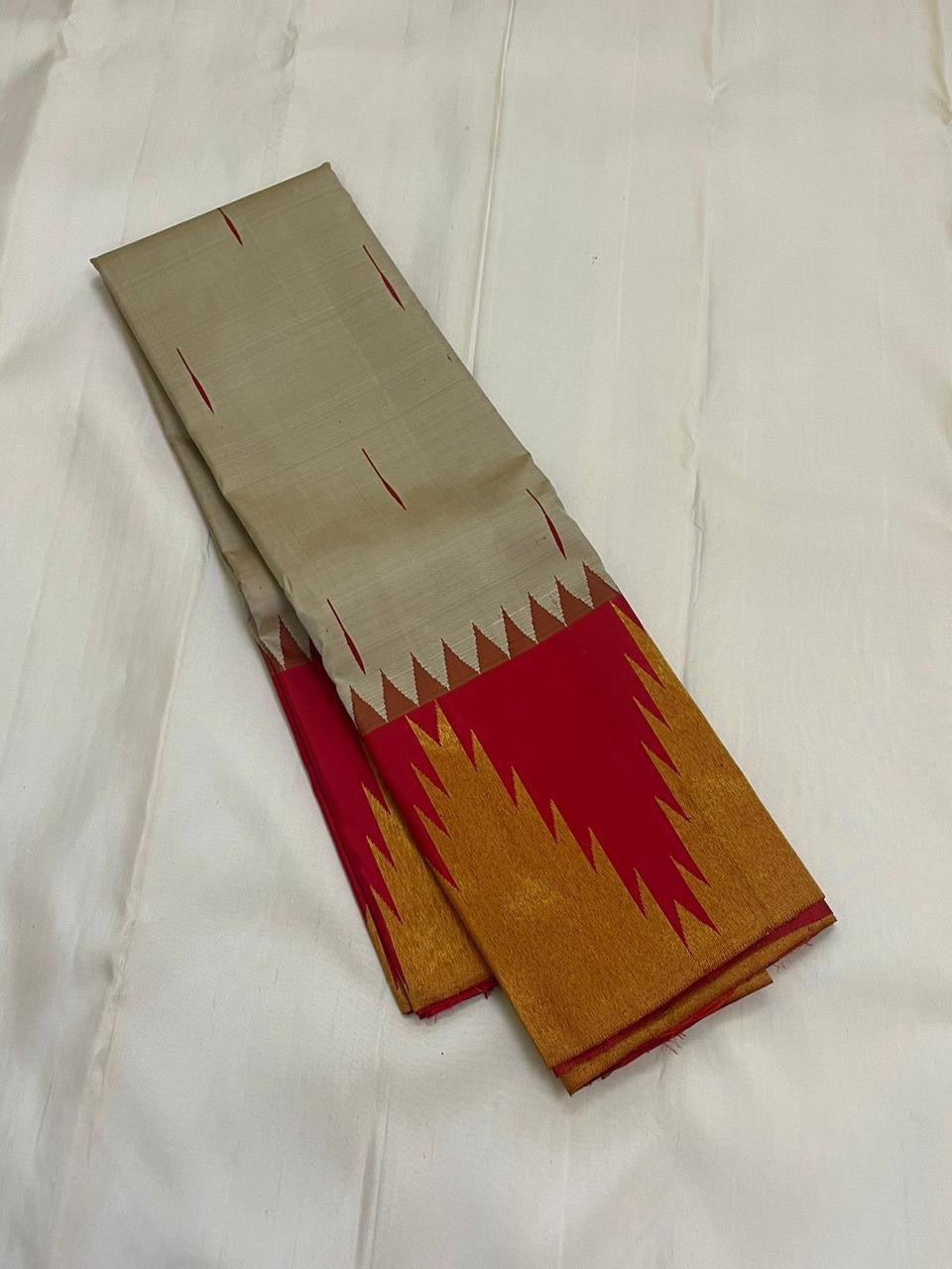 Vermillion Venpattu Ettukol — Pure Kanchipuram Silk 
Ivory venpattu body with fine red temple -motifs in ettukol weaving 
Vermilion-red &gold korvai temple (reku) borders
Mullai moggu woven motifs on body  
Silk Mark Certified | Free Shipping within US