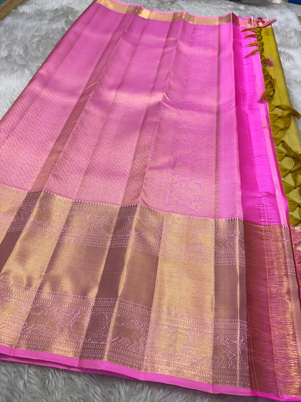 The color of “festive” vibrant golden sampanga with a pink border and Pallu pure silk Kanchipuram saree bavanji rettapet vanasringaram border
