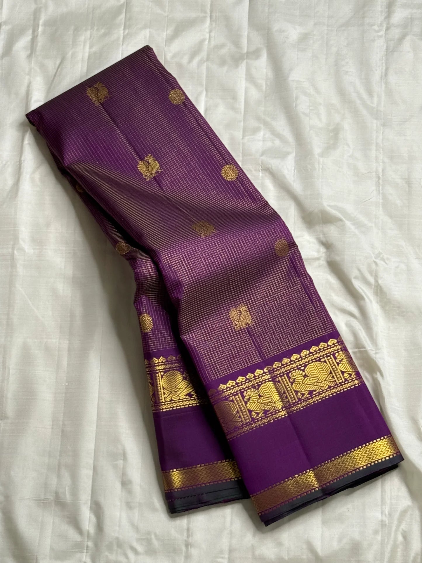 Kalika Purple — Pure Silk Kanchipuram Saree
Royal Purple with Gold Coin & Kalika Paisley Zari Buttas | Annapakshi Panel Border | Brocade Pallu
**Silk Mark Certified ✅ •ships in 2 weeks