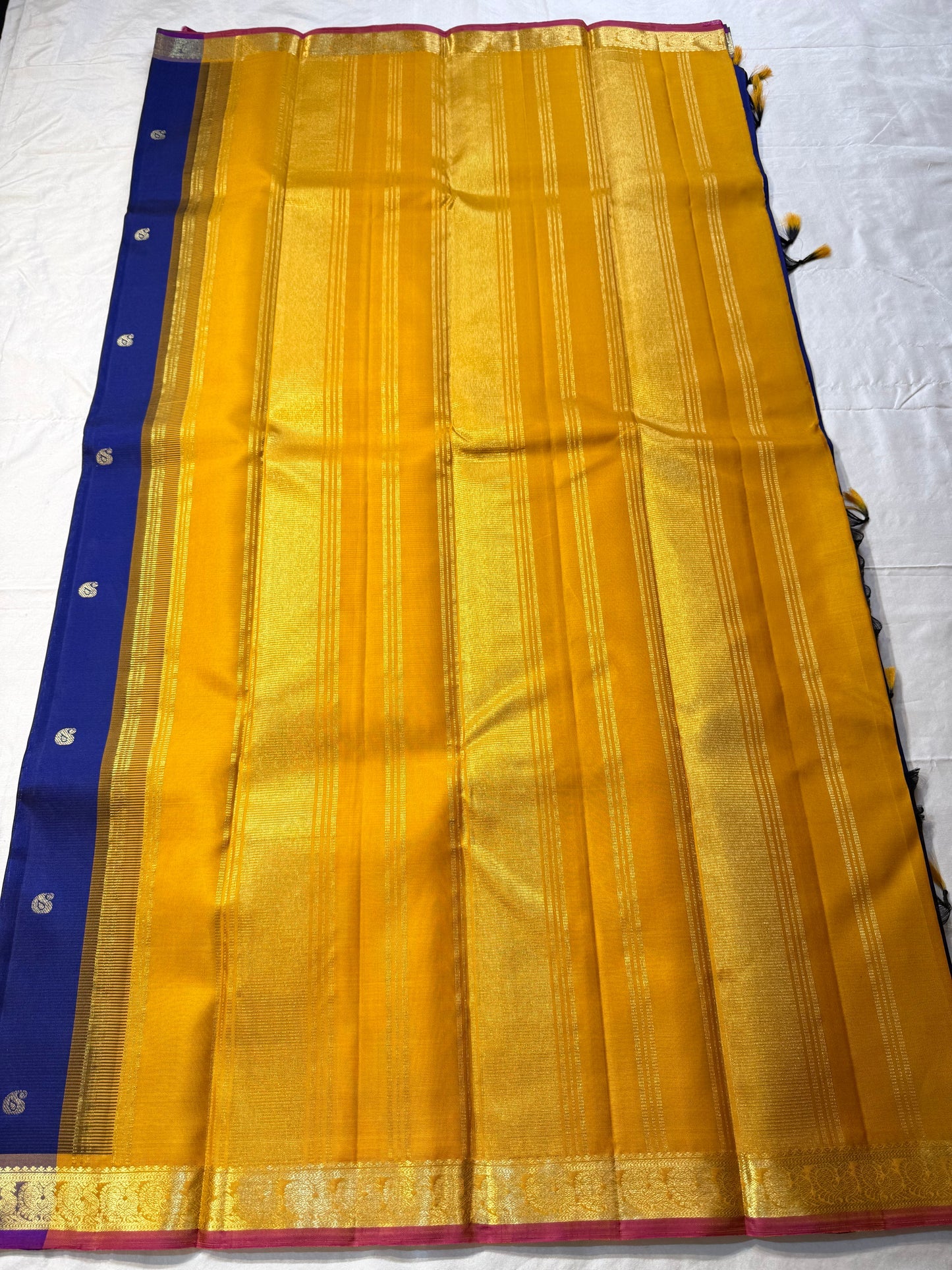 Devasri – Exquisite MS Royal Blue Silk Saree with Alternating Woven Zari Paisley & Floral Buttas, Petite Mauve-Purple Magenta Arai Maadam Border, and Breathtaking Golden Mustard Seer Pallu with Peacock Motifs