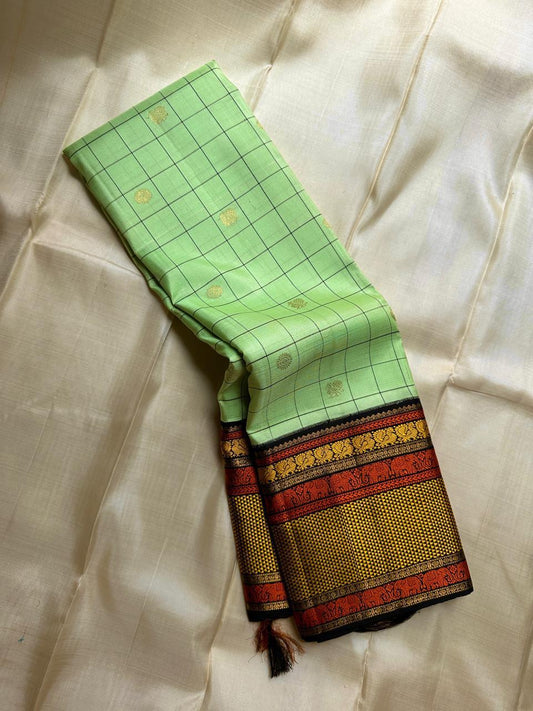 ✨ Elakkai Kattam — Pure Silk Kanchipuram Saree ✨
Cardamom-green body with black kattam checks and gold buttas, contrasted by kumkum-rust & kanak-gold borders with elephant zari and a rich black brocade pallu.
Silk Mark Certified ✅ • Fall & Pico Done ✅ •