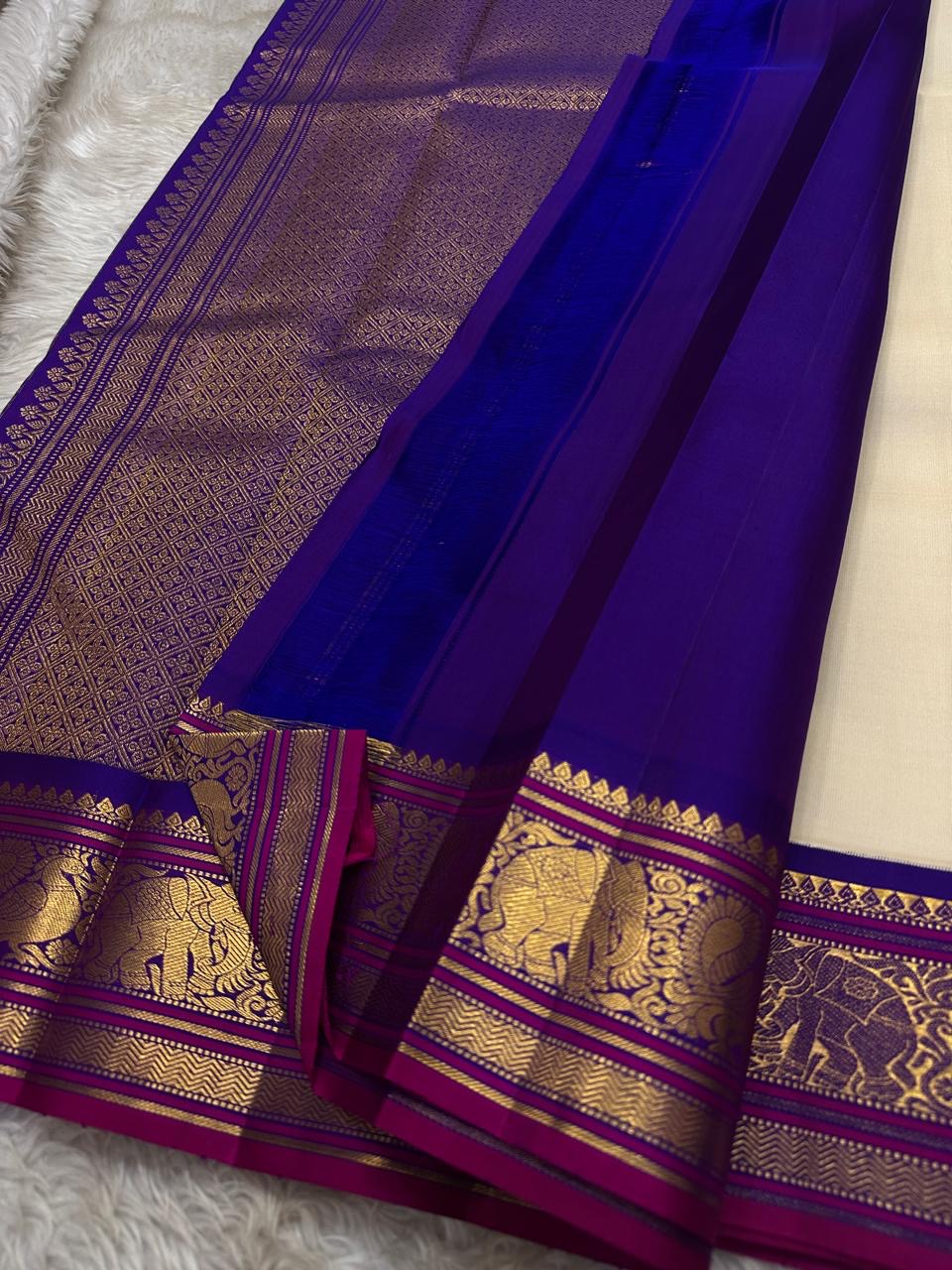 ⸻
Ivory Glow ✨ – Pure Kanchipuram Silk Saree in Ivory
Korvai Royal-Purple Border with Elephant & Peacock Zari Panels; Magenta Selvedge
Body with Gold Coin & Paisley Buttas
Grand Royal-Purple Brocade Zari Pallu with Hand-knotted Tassels