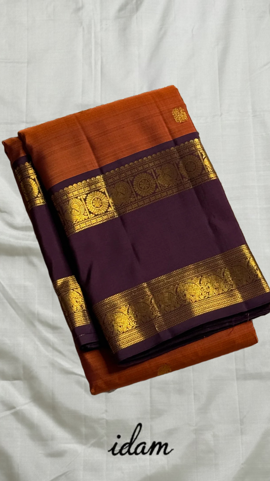 Poovizhi Rust Orange — Pure Kanchipuram Silk Saree
Deep aubergine body with rust-orange korvai borders & rich zari floral motifs
Silk Mark Certified • Blouse Stitching ($30) • Free Shipping within USA • Ships in Two Weeks