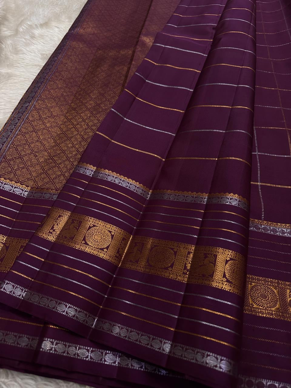 Pankajam 🌺 — a brown-purple jamun Kanchipuram silk saree woven with silver & gold zari kattam, delicate kolam motifs, and a deep magenta-purple selvedge. The Sona Roopa pallu shimmers with ornate grids and intricate motif