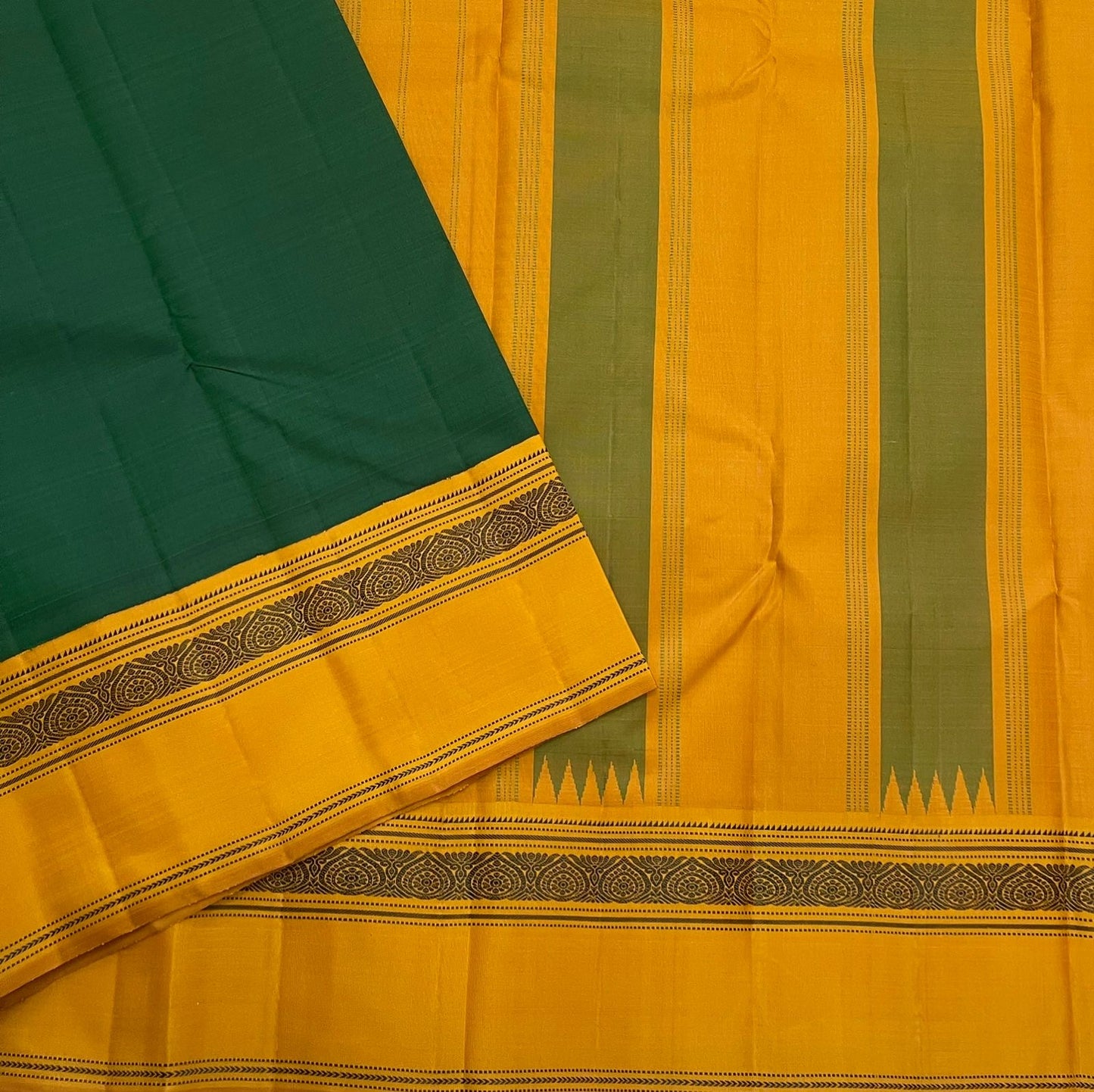 Maragatham & Mustard — Pure Silk Kanchipuram Saree
Emerald-green body with mustard korvai borders & floral medallion vines, varisaipettu pallu with tassels.
Silk Mark Certified • Ships in Two Weeks • Free USA Shipping ✅