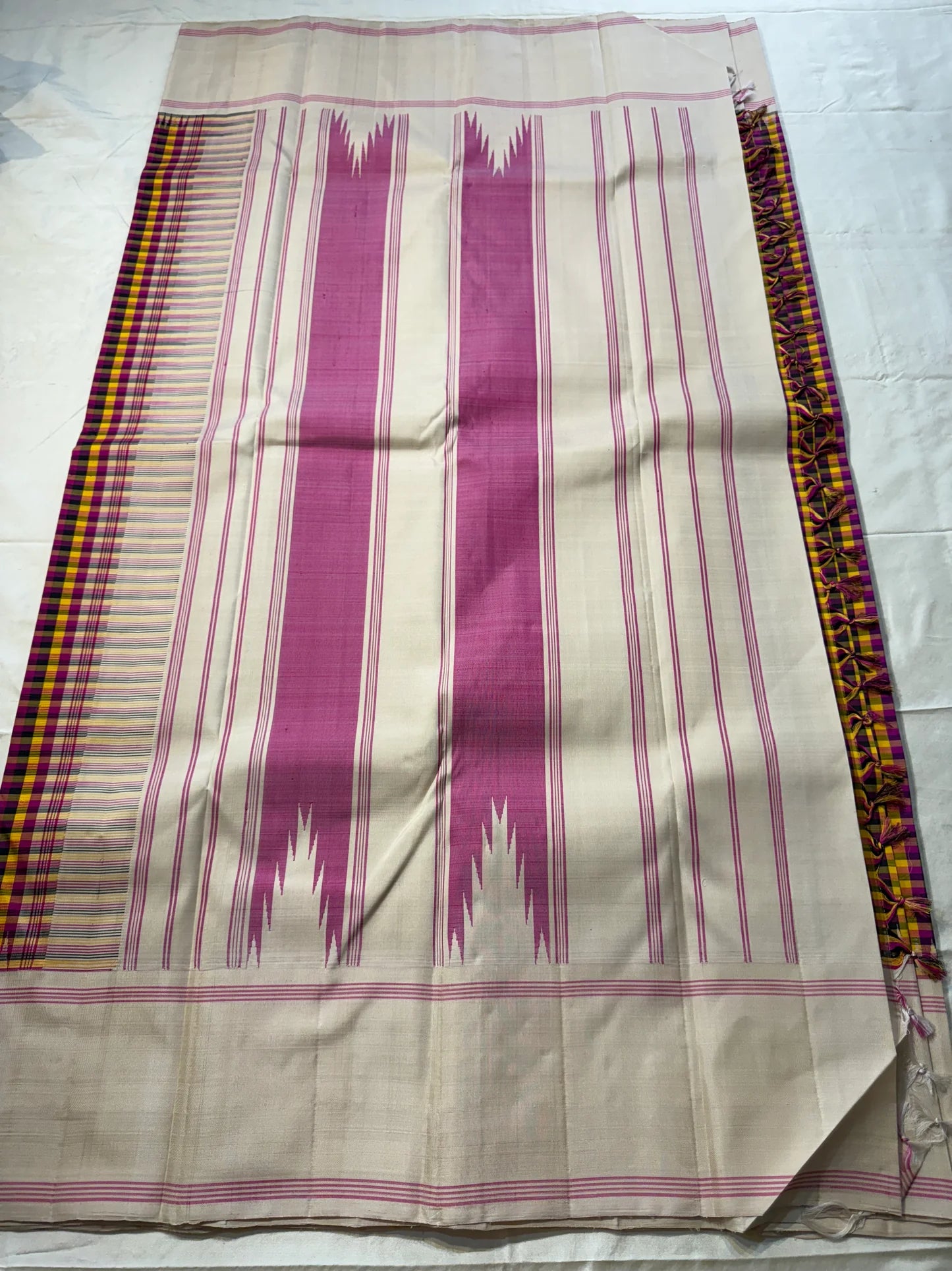 Venpattu Kattam Thazampoo Reku — Pure Kanchipuram Silk Saree
Multicolor kattam body: rani pink • manjal yellow • ink blue/black • deep purple/green accents
(venpattu) borders with pink selvedge lines & thazampoo reku 
Silk Mark Certified  free shipping