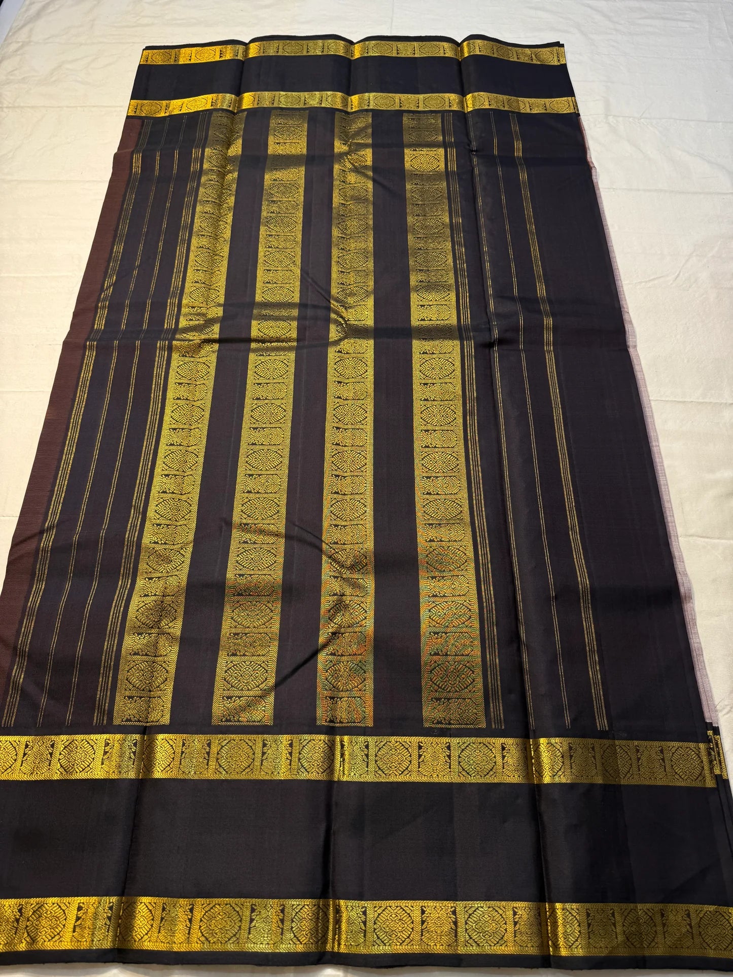 Ash Rose Butta — Pure Silk Kanchipuram
• Dusty ash-rose body with gold buttas
• Inky-black broad borders with antique-gold zari
• Black contrast pallu with zari stripe panels & tassels
• Silk Mark Certified • Ships in Two Weeks • Free Shipping within