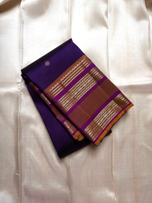 Swarna Laya — Pure Silk Kanchipuram Saree
Deep vaadamalli purple with gold zari buttas, antique-gold border, and rich striped pallu.
Silk Mark Certified • Free USA Shipping • Ships in Two Weeks.