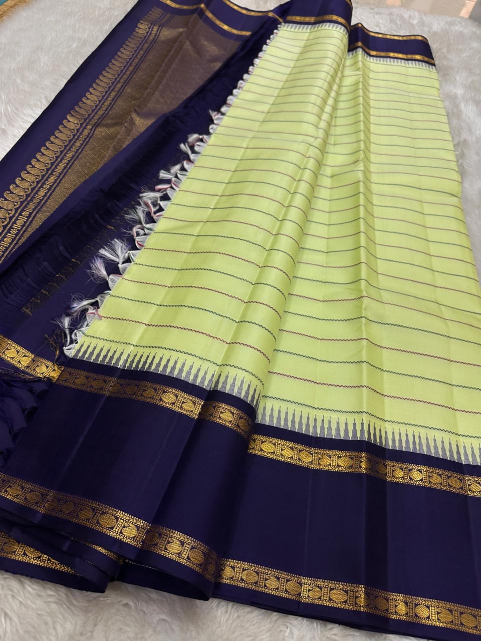 Cardamom veldhari Stripes – Pure Silk Kanchipuram Saree
Refreshing Cardamom Green Body with Stripes 🌿
Deep Purple Contrast Border in Rich Zari Weave ✨
Temple Motif Edging & Grand Lattice Pallu
Silk Mark Certified | ships two weeks