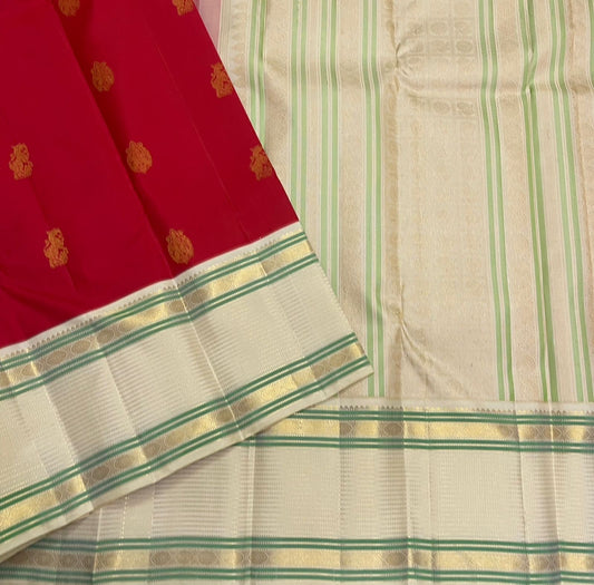 Yazhi Venpattu — Pure Silk Kanchipuram
Kumkum-red body with gold mankolam buttas & ivory korvai borders in mint-green lines ✨
Silk Mark Certified • Ships in Two Weeks • Free Shipping within USA