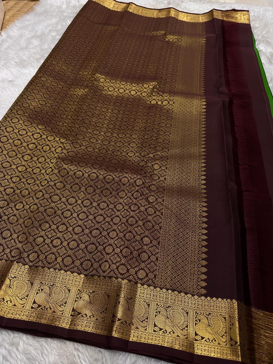 Green pure silk Kanchipuram saree with zari motif wirh deep chocolate brown shot purple silk Kanchipuram saree with vanasringaram border and Pallu