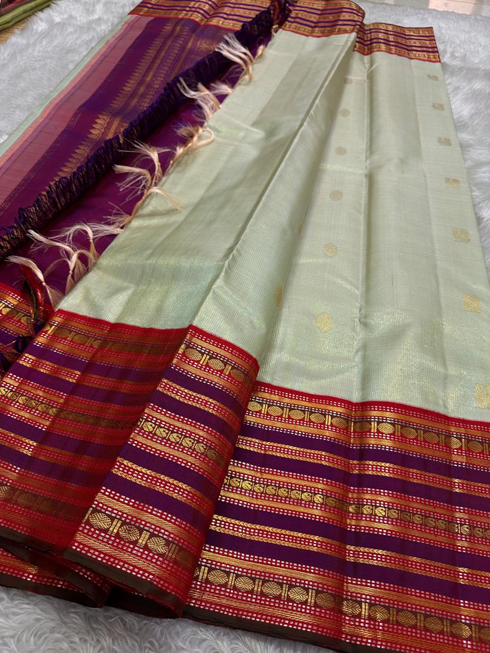 Pure silk kanchipuram grey with sampanga green vairaoosi with detailed ornate varisaipet border thandavalam zari , mayil Butta