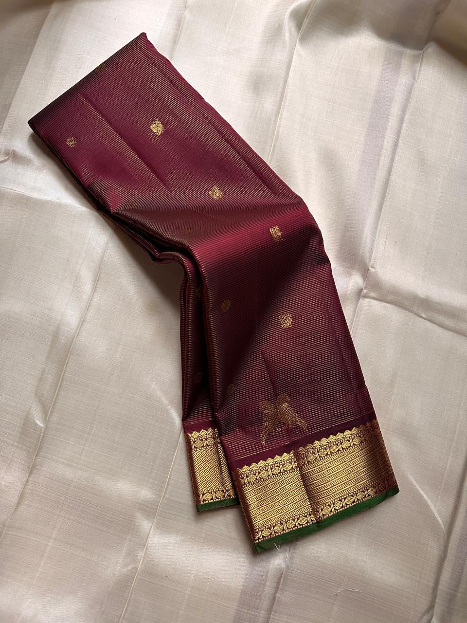 Kili Brown Maroon ✨
Vairaoosi Pure Silk Kanchipuram Saree
With Gold Kili (Parrot) Motifs
Vanki Neli Border with Arai Maadam & Rudhraksham Pet
Opulent Grid Zari Pallu & Matching Blouse