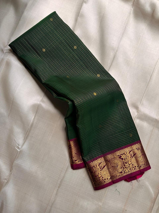 Hemavalli Zari Kattam: Stunning Emerald Green & Rani Pink Korvai Pure Silk Kanchipuram with Gold Zari Checks
Silk Mark Certified for Quality Assurance, Enjoy Free Shipping within USA.
Ready to Ship in 2 Weeks with Majestic Peacock Borders.