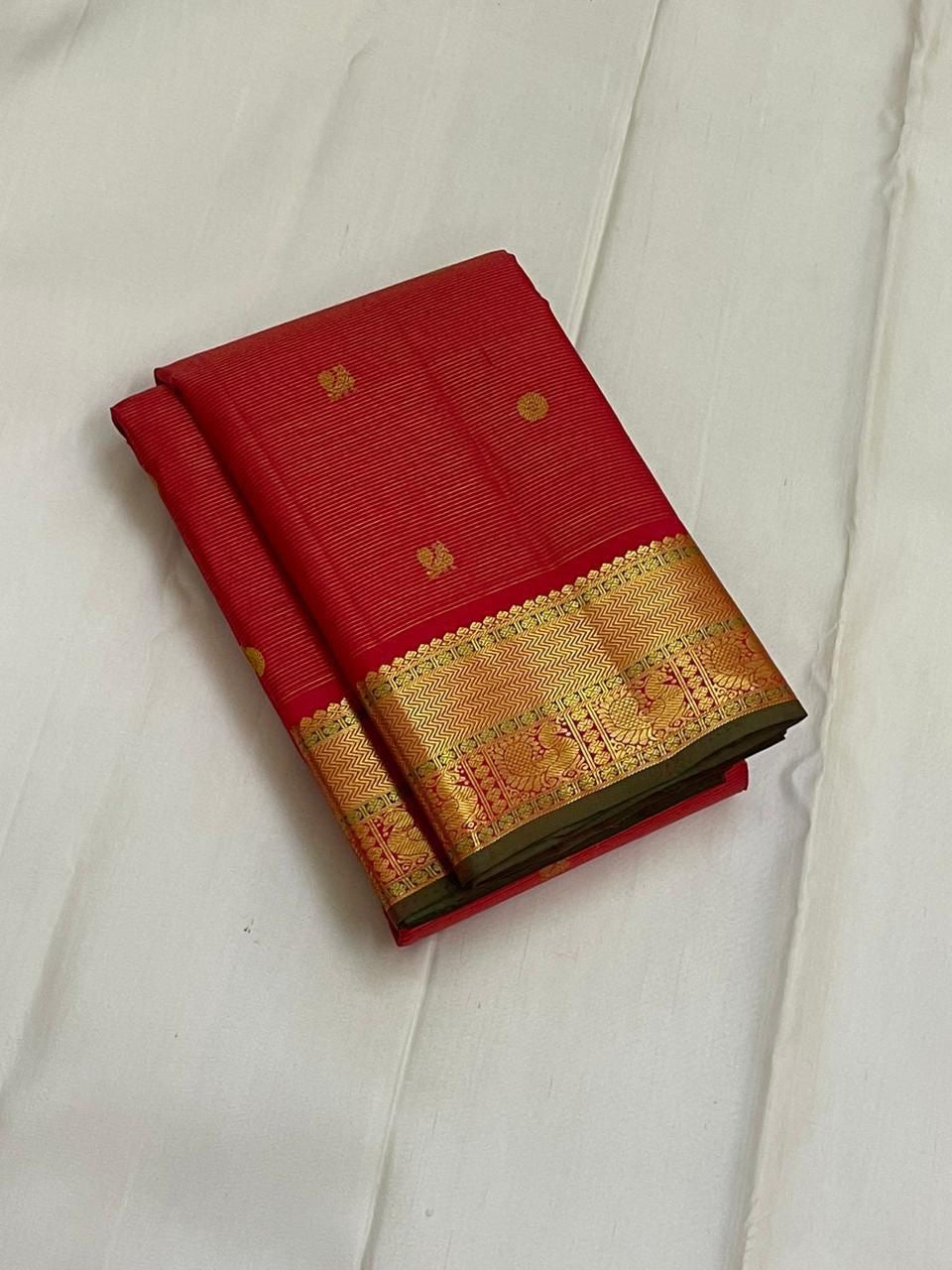 Sringaram Red Vairaoosi – Pure Kanchipuram Silk Saree
Red body with zari coin & floral buttas;
Broad gold border with vairaoosi l & peacock panel; Zari pallu
Silk Mark Certified | Blouse Piece Included | Fall & Pico Done
…read description
