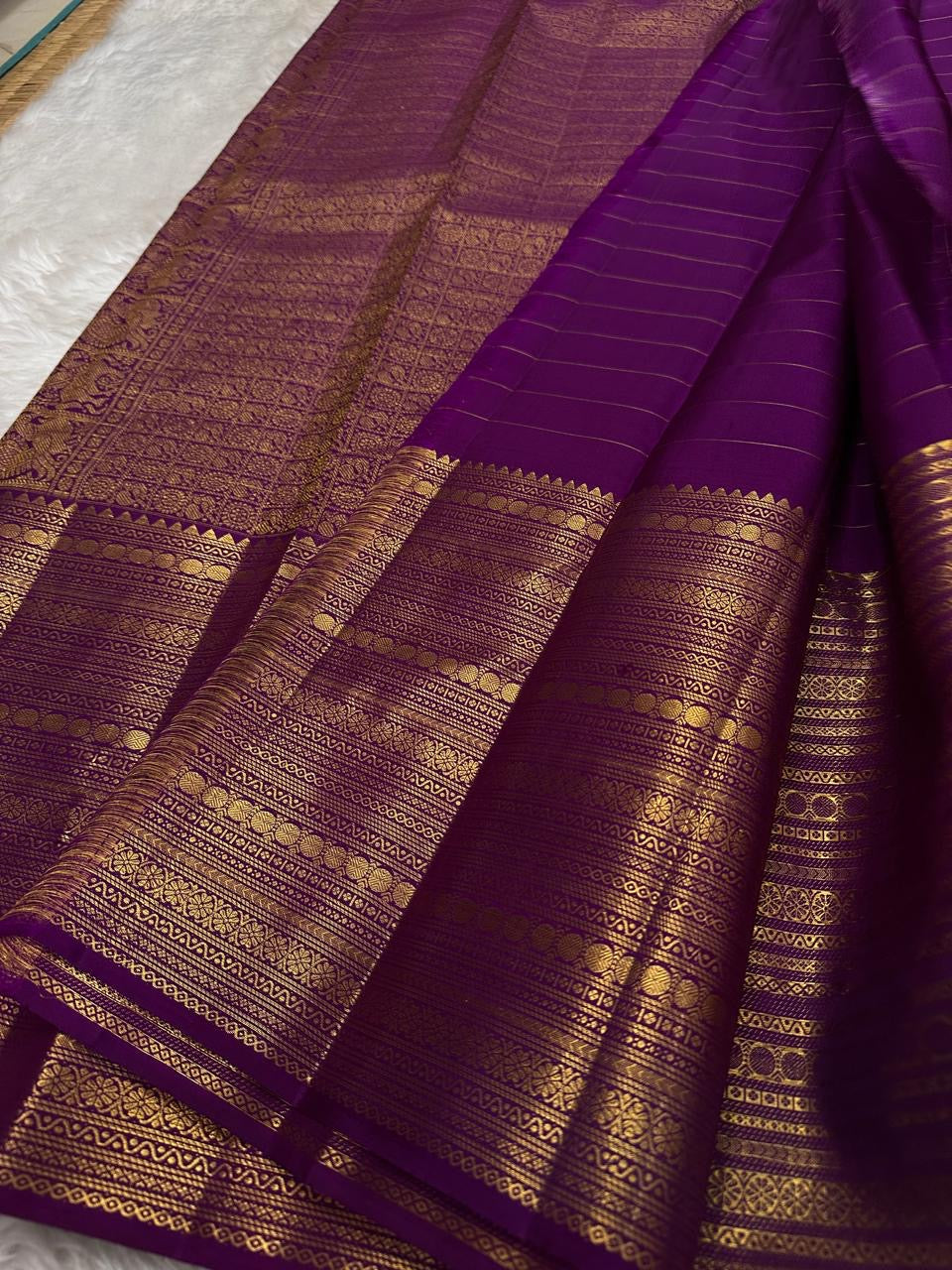 Purple with gold Zari kattam with ornate border pure silk Kanchipuram with mayil chakram zari butta and detailed Pallu