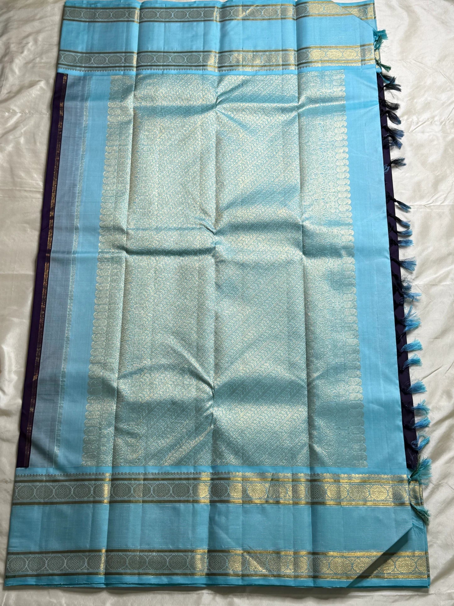 Moora – Handwoven Pure Kanchipuram Silk Saree in Deep Regal Purple with Lustrous Contrast Aqua Blue Border and Grand Pallu, Featuring Intricate Gold Zari Weaving with Traditional Round Medallions, Paisley Buttas, and Concentric Floral Vine Patterns