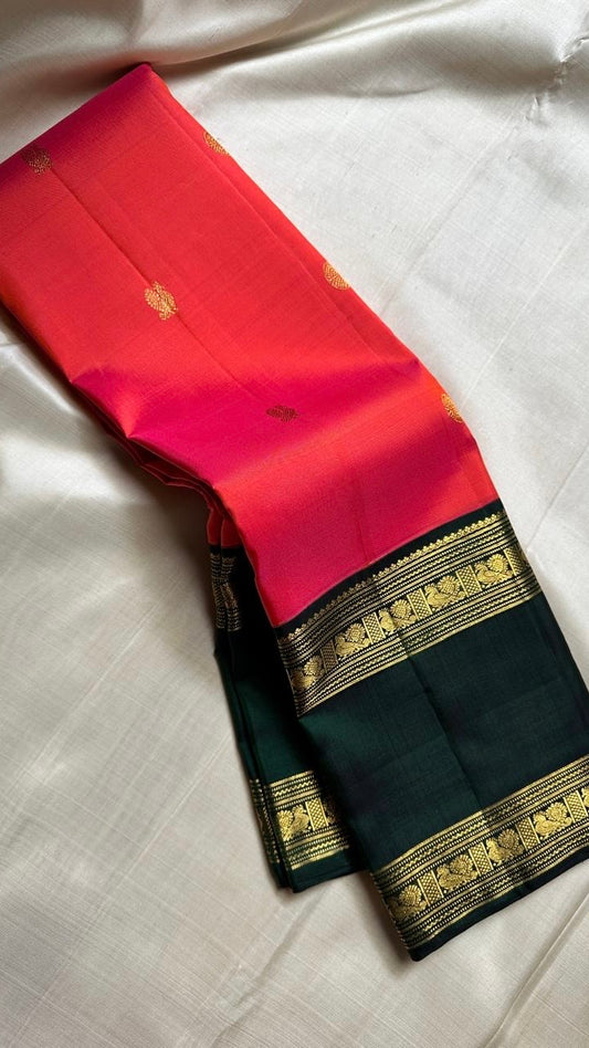 Pure silk kanchipuram handloom saree with tomato pinkish orange body mayil floral butta green border intricate pallu