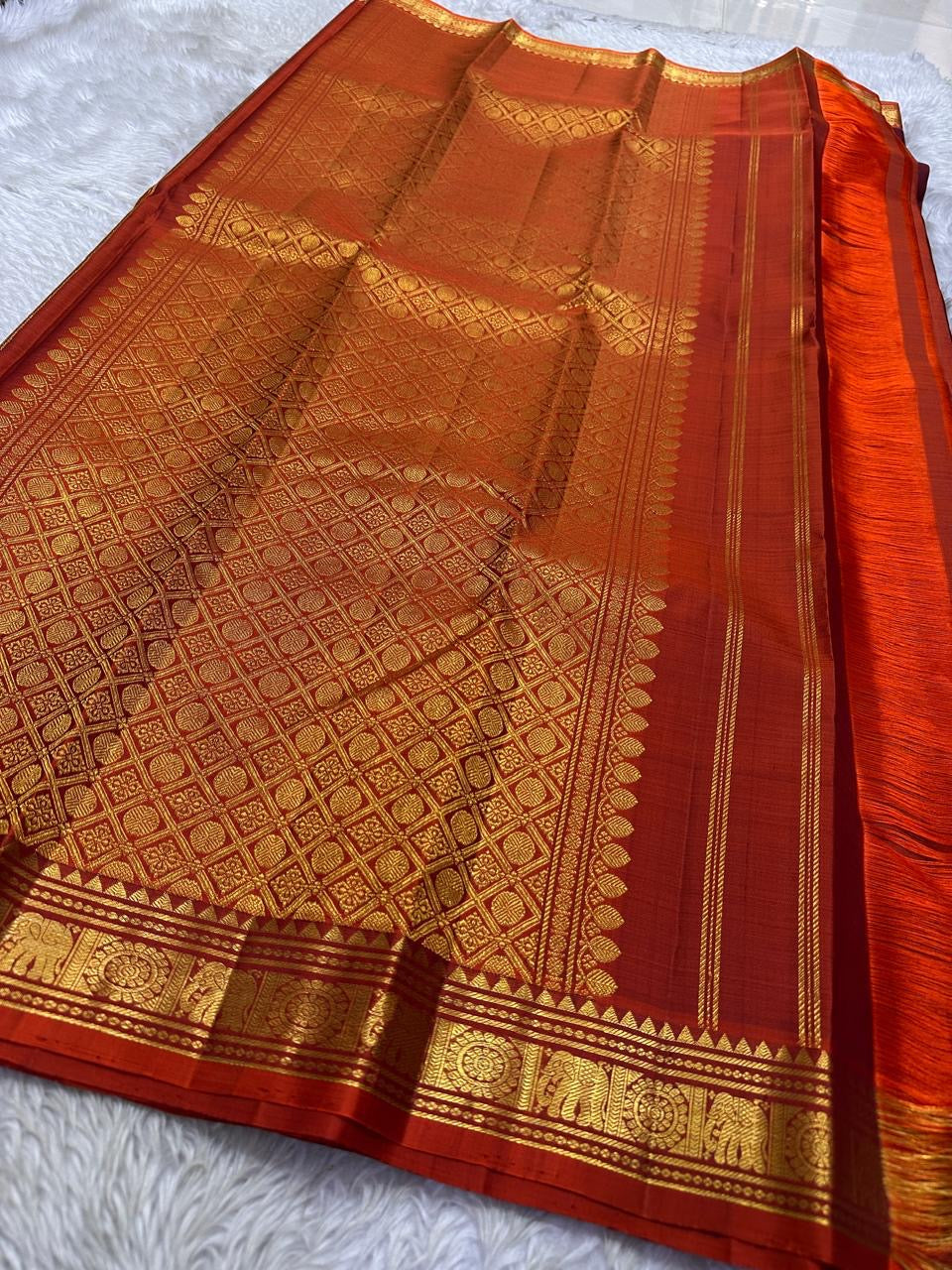Maroon Kolam Korvai – deep wine-maroon body with tiny kolam buttas
Contrast burnt-orange korvai border with temple triangles & intricate kolam motifs
Silk Mark Certified | Fall & Pico Done | Blouse Stitching Available ($30)
Free Shipping 2 weeks