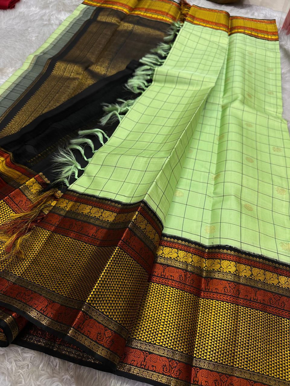 ✨ Elakkai Kattam — Pure Silk Kanchipuram Saree ✨
Cardamom-green body with black kattam checks and gold buttas, contrasted by kumkum-rust & kanak-gold borders with elephant zari and a rich black brocade pallu.
Silk Mark Certified ✅ • Fall & Pico Done ✅ •