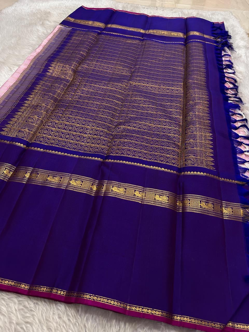Petal Purple — Pure Silk Kanchipuram Saree (Handloom)
Petal-pink body with gold kattam checks & floral buttas • Vadamalli purple border with antique-gold zari
Silk Mark Certified • Free USA Shipping • Ships in Two Weeks
