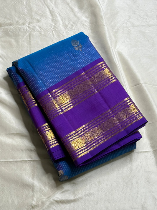Azure Blue Purple Horizon – Neelam blue body with royal-purple korvai borders  Pure Kanchipuram silk • manga (paisley) buttas + fine pin-stripes  Opulent purple brocade pallu • contrast blouse with zari border  Silk Mark Certified | Fall & Pico Done |