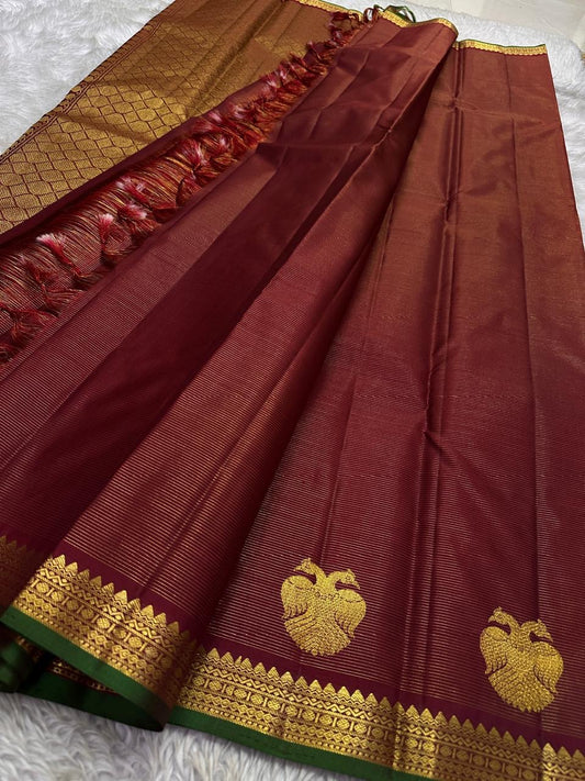 Arakku Gandaberunda vairaoosi — Pure Silk Kanchipuram Saree
Deep arakku  in fine vaira oosi weave with gold Gandaberunda motifs 🦅
Antique-gold temple borders & emerald-green selvedge • Silk Mark Certified • Free USA Shipping • Ships in Two Weeks ✅