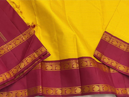 Arakku Kanakam — Pure Silk Kanchipuram Saree
Basanti yellow body with fine varisai pinstripes and rich arakku korvai borders adorned with gold shankh motifs ✨
Silk Mark Certified • Free USA Shipping • Ships in Two Weeks ✅