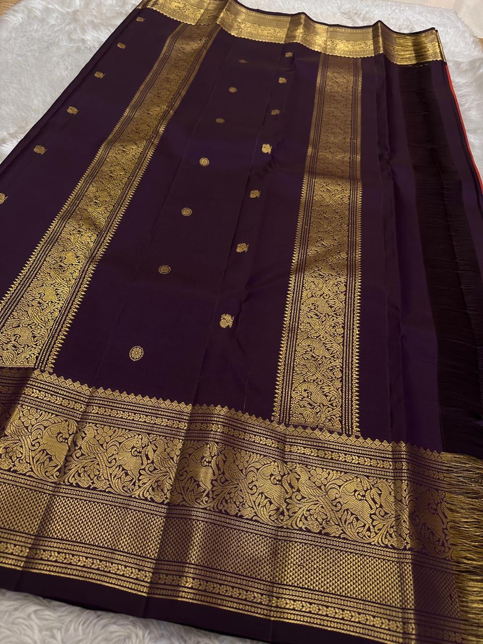 Shyama – Dusky Tangerine Kanchipuram Silk Saree with Purple Vanasringaram Border & Mayil Buttas