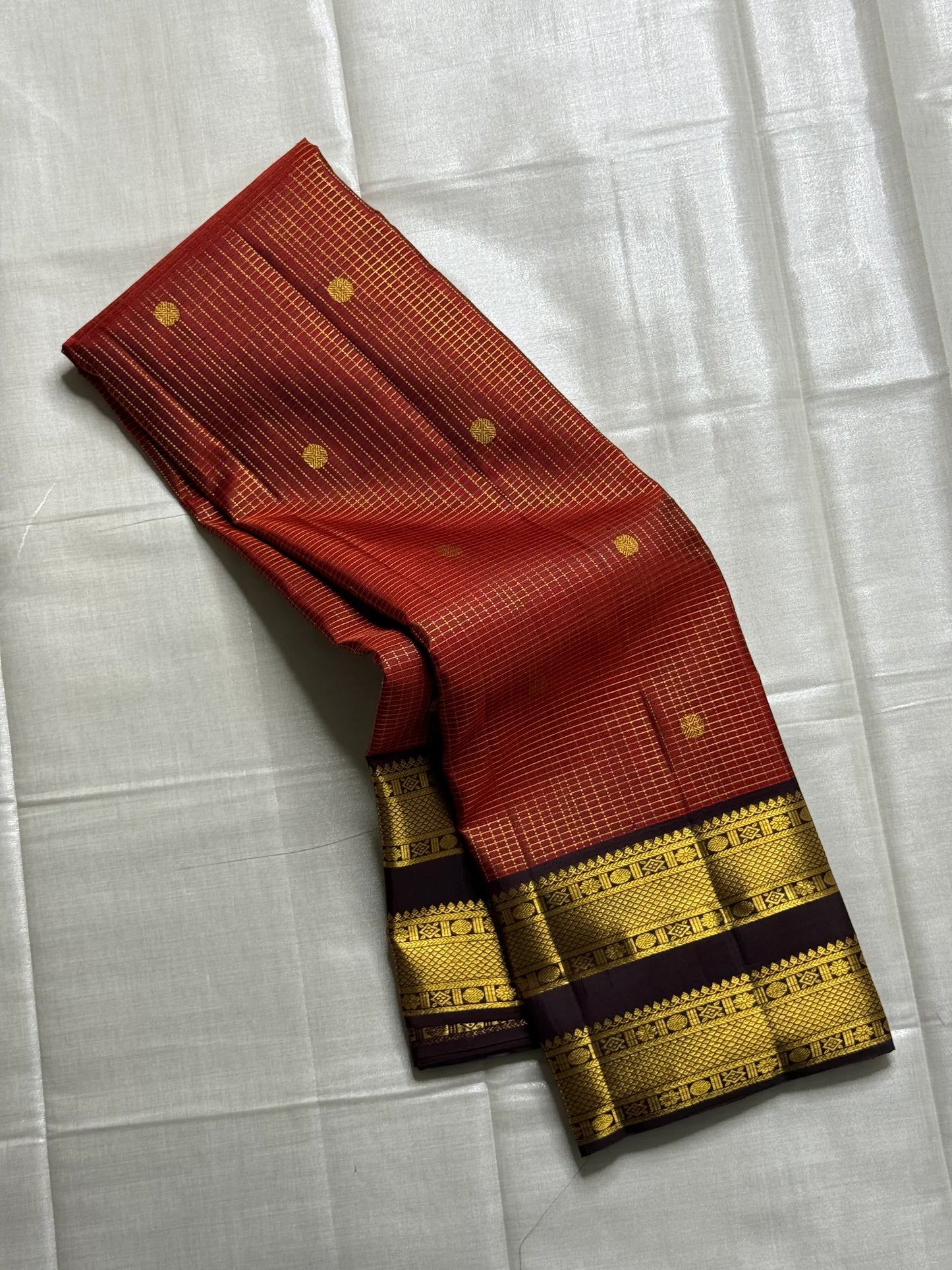 Amber Cocoa – Pure Kanchipuram Silk Saree
Warm cocoa-brown body with elegant zari kattam checks & buttas ✨
contrast border richly woven with zari motifs
zari pallu adorned with intricate patterns
Silk Mark Certified, ships in two weeks